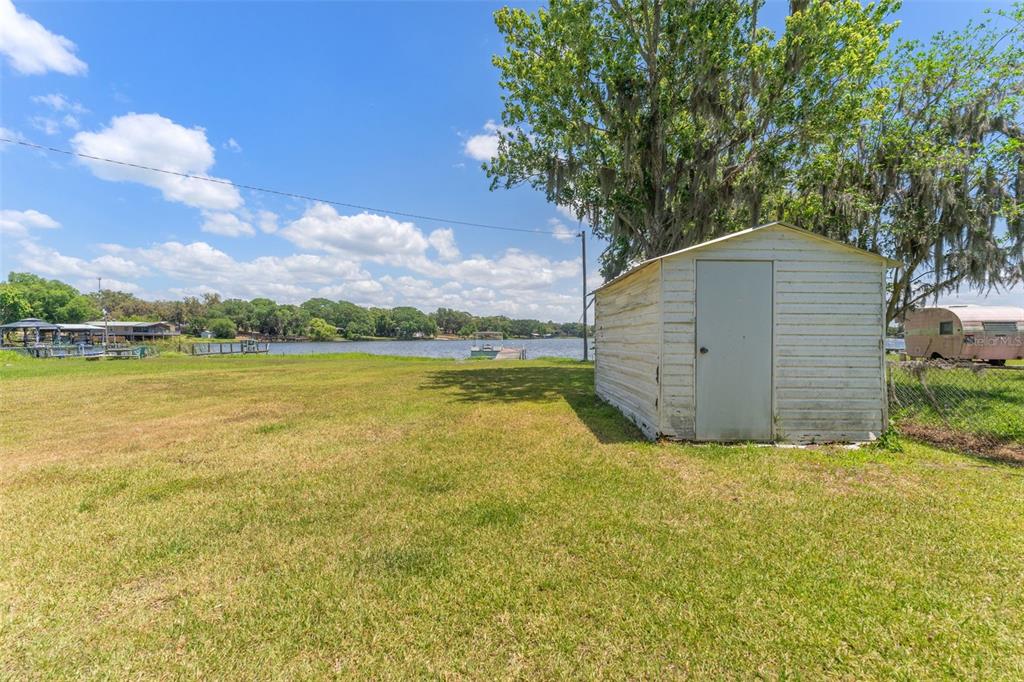7558 Berkley Road Polk City, FL 33868 - Photo 11 of 16 a view of a wooden floor and a yard in front of the house