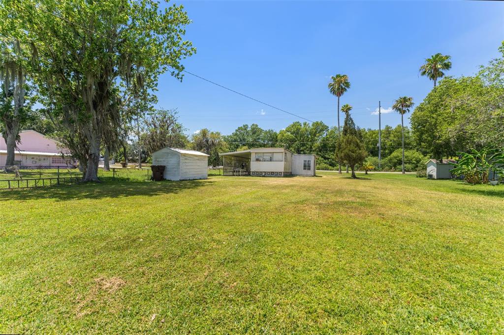 7558 Berkley Road Polk City, FL 33868 - Photo 12 of 16 a house view with swimming pool in front of it
