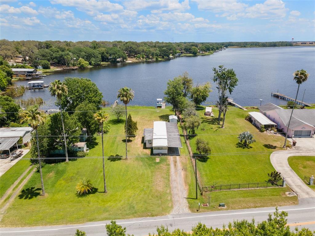 7558 Berkley Road Polk City, FL 33868 - Photo 5 of 16 a view of a lake with a building in the background