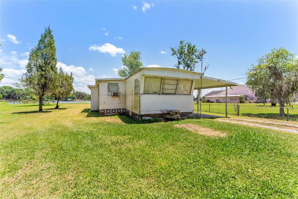 7558 Berkley Road Polk City, FL 33868 - Photo 7 of 16 a view of a house with a yard