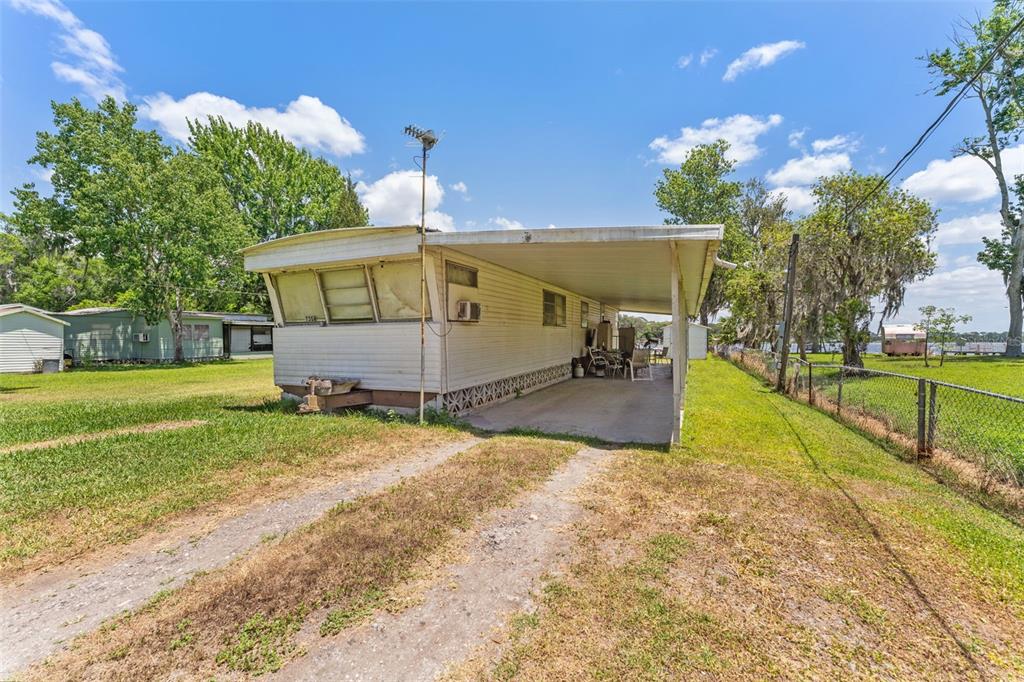 7558 Berkley Road Polk City, FL 33868 - Photo 8 of 16 a view of a house with a yard
