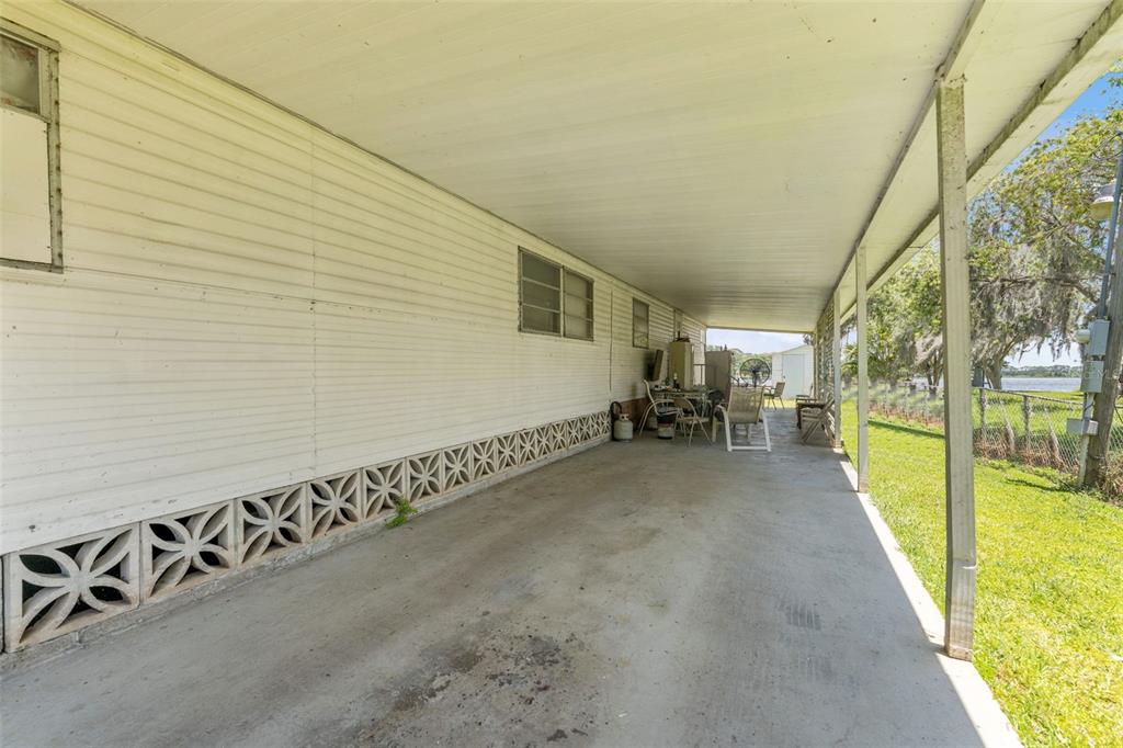 7558 Berkley Road Polk City, FL 33868 - Photo 9 of 16 a view of a patio with table and chairs