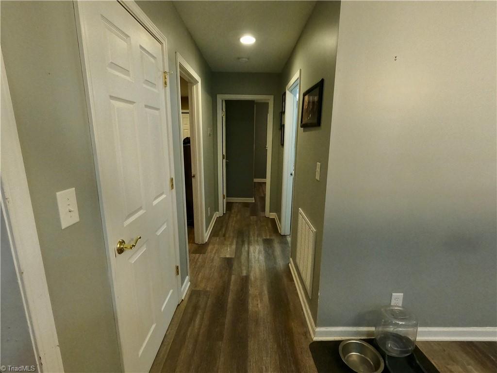 1850 Cromer Road King, NC 27021 - Photo 5 of 49 Kitchen hallway view to Primary (L) and BR (end of hall) and full bath on right.