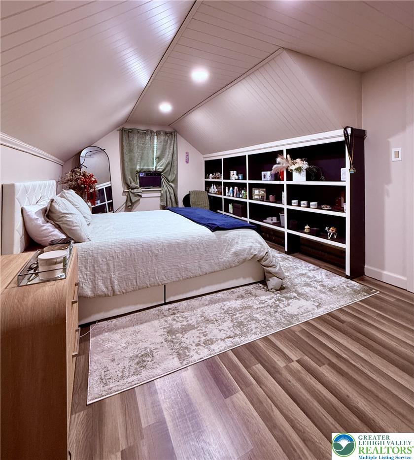 1275 Macada Road Bethlehem, PA 18017 - Photo 60 of 87 Sloped ceilings and rich wood flooring create a cozy, inviting bedroom space.