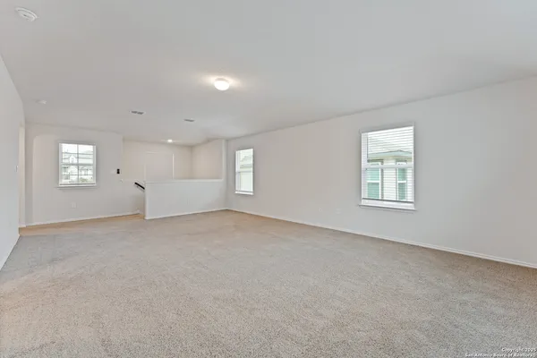 a view of an empty room with windows