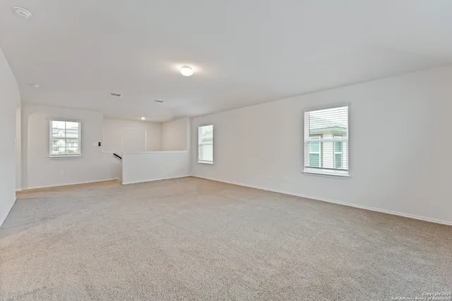 a view of an empty room with windows