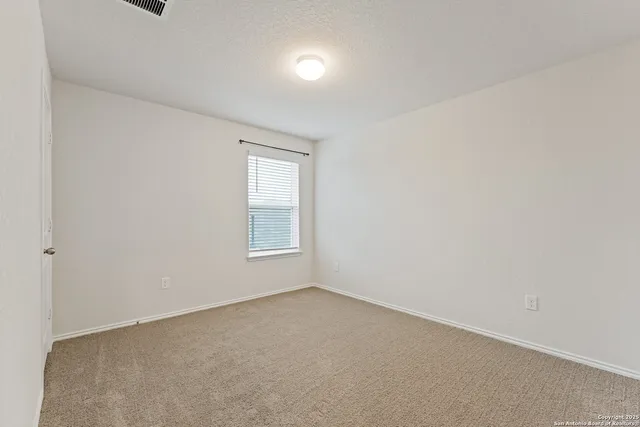 a view of an empty room and a window