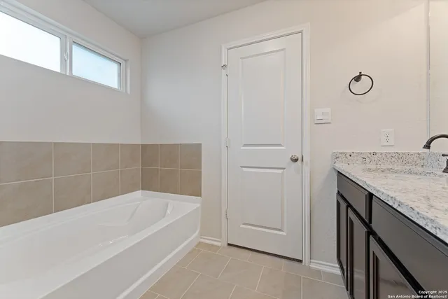 a view of bathroom with bathtub and window