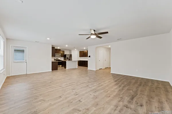 a view of an empty room with a kitchen