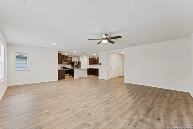 a view of an empty room with a kitchen