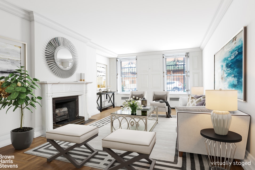 a living room with furniture a fireplace and a large window