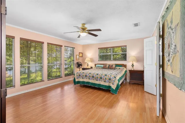 a bedroom with a large bed and a large window