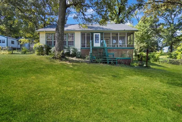 a view of an house with backyard space and garden