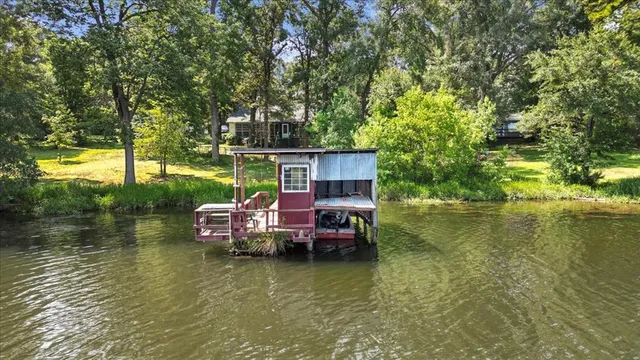 a view of a lake with a house swimming pool and outdoor space