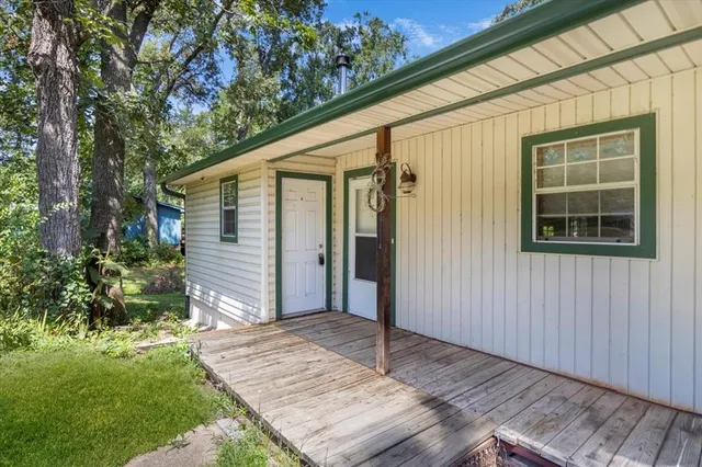 a view of backyard with plants and wooden fence