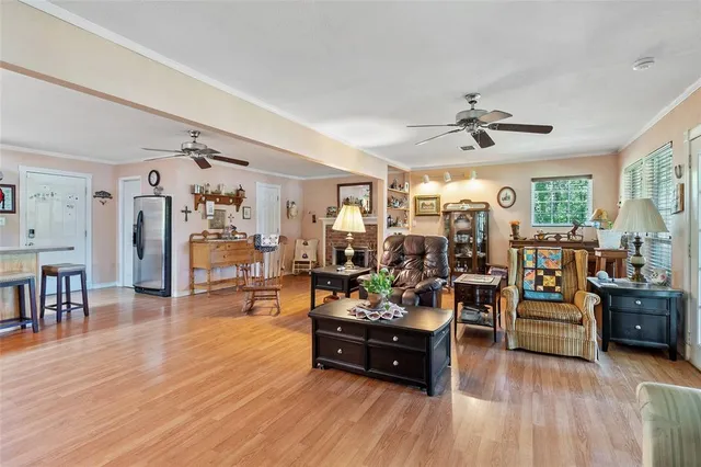 a living room with lots of furniture and wooden floor