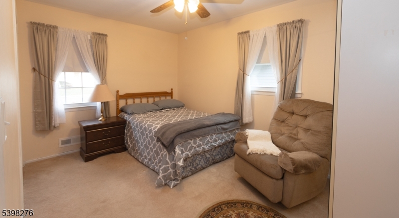 169 Valley View Road Hillside, NJ 07205 - Photo 11 of 32 a bedroom with a bed and a couch