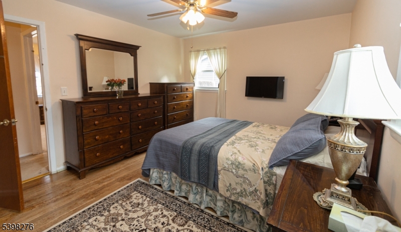 169 Valley View Road Hillside, NJ 07205 - Photo 12 of 32 a bedroom with a bed and a mirror on dresser