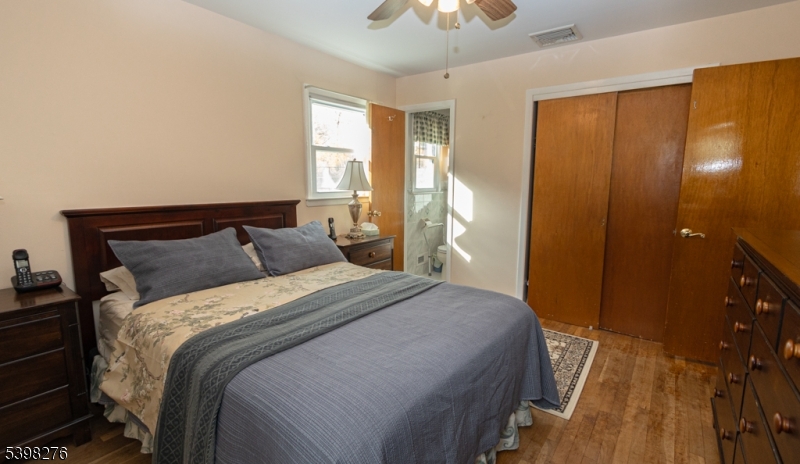 169 Valley View Road Hillside, NJ 07205 - Photo 13 of 32 a bedroom with a bed and a chandelier