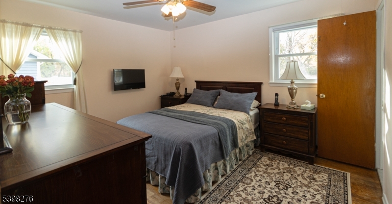 169 Valley View Road Hillside, NJ 07205 - Photo 14 of 32 a bedroom with a bed and a chandelier