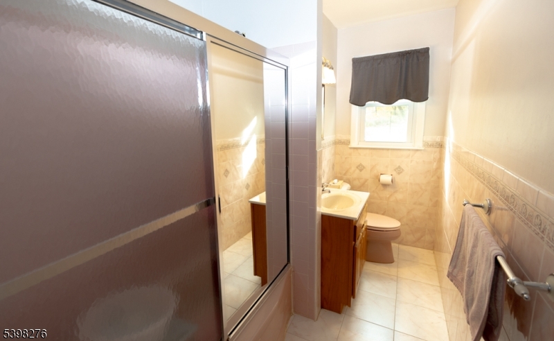 169 Valley View Road Hillside, NJ 07205 - Photo 16 of 32 a bathroom with a sink and a mirror