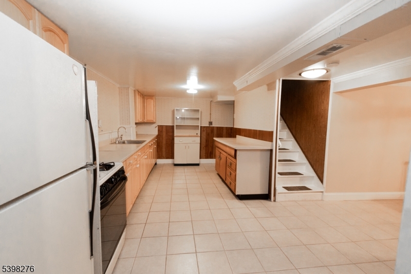 169 Valley View Road Hillside, NJ 07205 - Photo 26 of 32 a view of a kitchen with furniture and stairs