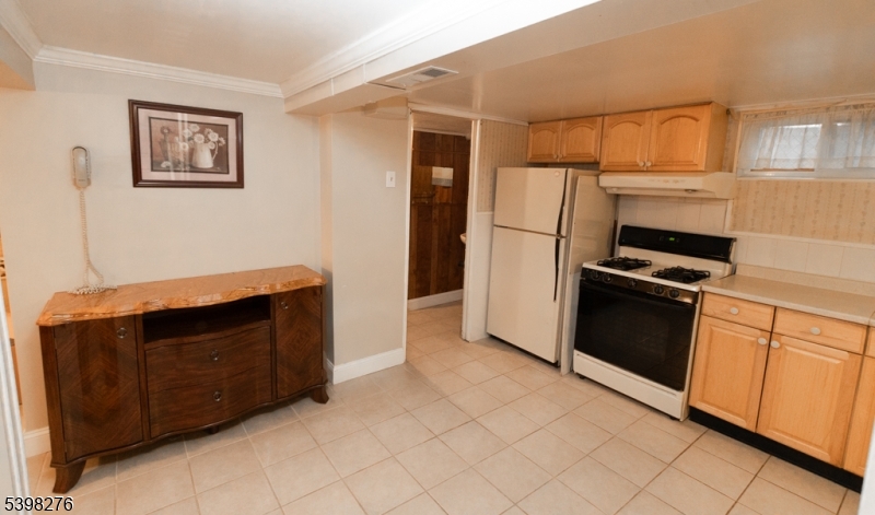 169 Valley View Road Hillside, NJ 07205 - Photo 27 of 32 a kitchen with granite countertop a refrigerator and a stove