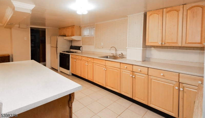 169 Valley View Road Hillside, NJ 07205 - Photo 28 of 32 a kitchen with granite countertop white cabinets and sink