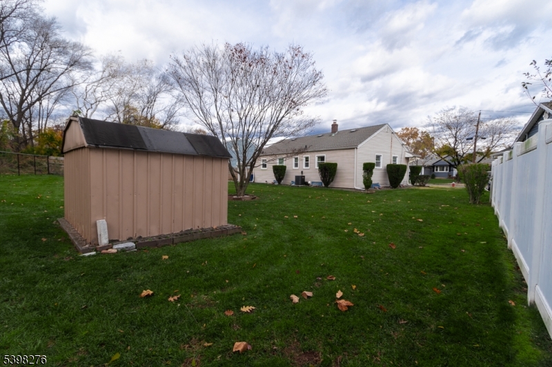 169 Valley View Road Hillside, NJ 07205 - Photo 30 of 32 a view of a house with a big yard and large trees