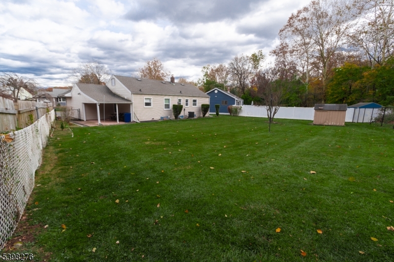 169 Valley View Road Hillside, NJ 07205 - Photo 32 of 32 a view of a big yard with plants and large trees