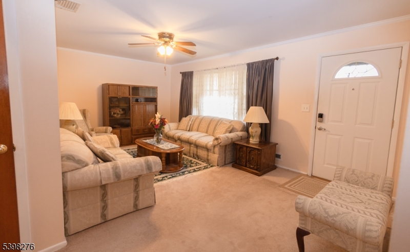 169 Valley View Road Hillside, NJ 07205 - Photo 8 of 32 a living room with furniture and a fireplace