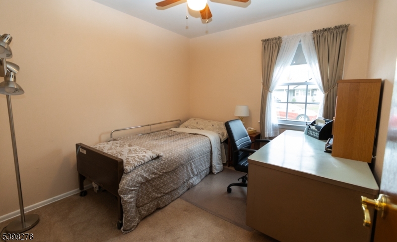 169 Valley View Road Hillside, NJ 07205 - Photo 9 of 32 a bed sitting in a bedroom next to a window