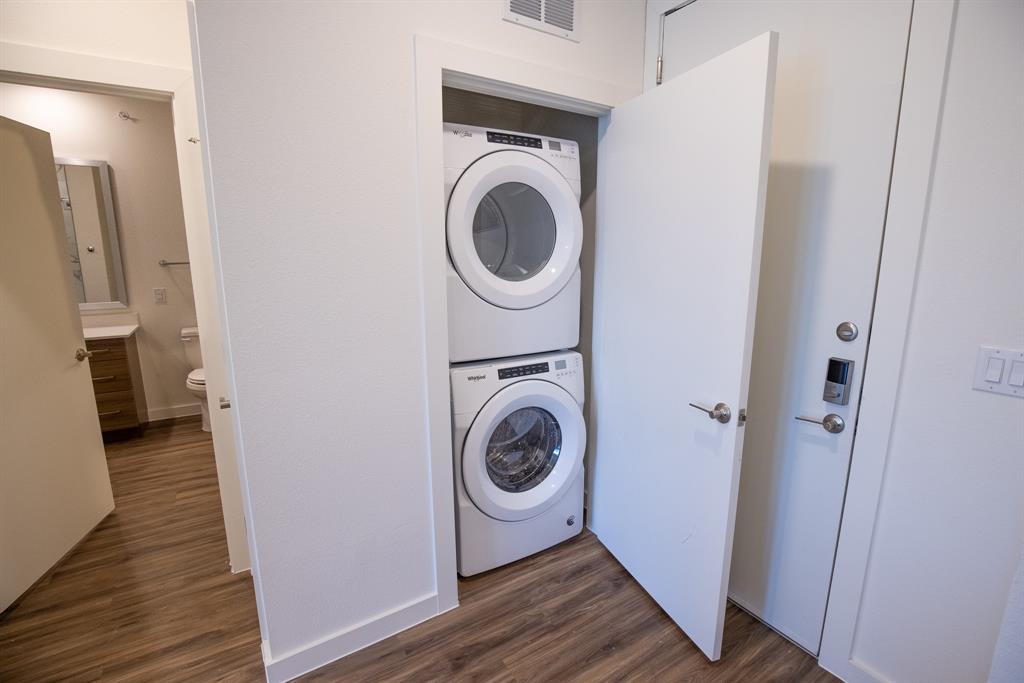 120 North Madison Avenue, Unit 1210 Dallas, TX 75208 - Photo 5 of 9 a storage room with wooden floor washer and dryer