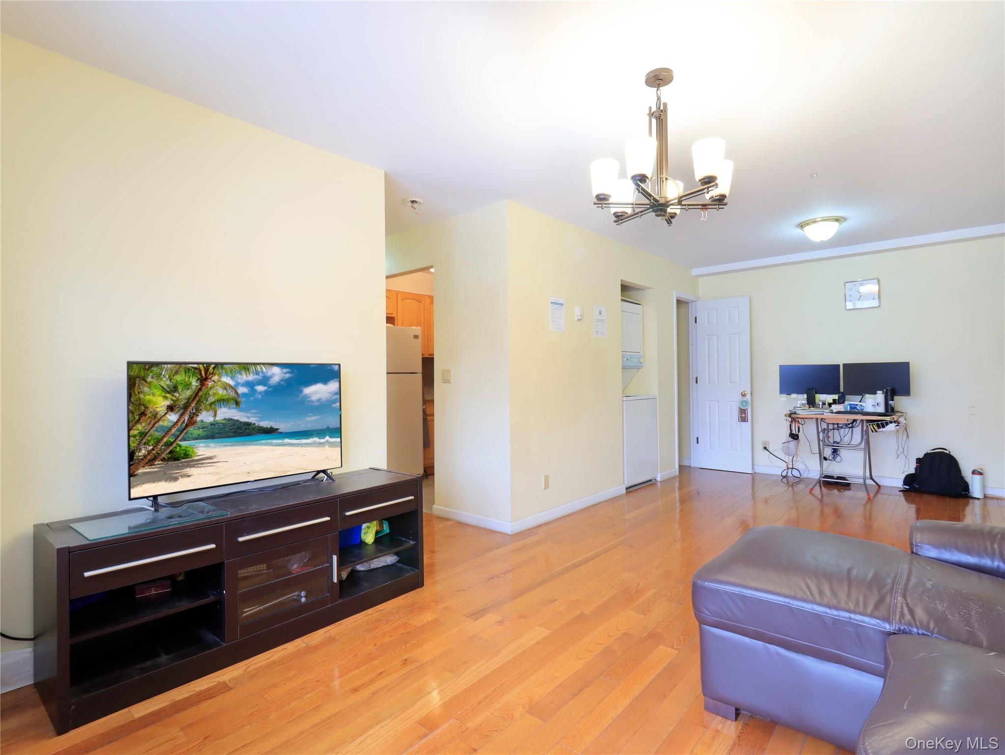 137-08 31st Road, Unit 5E Queens, NY 11354 - Photo 10 of 14 a living room with furniture and a flat screen tv