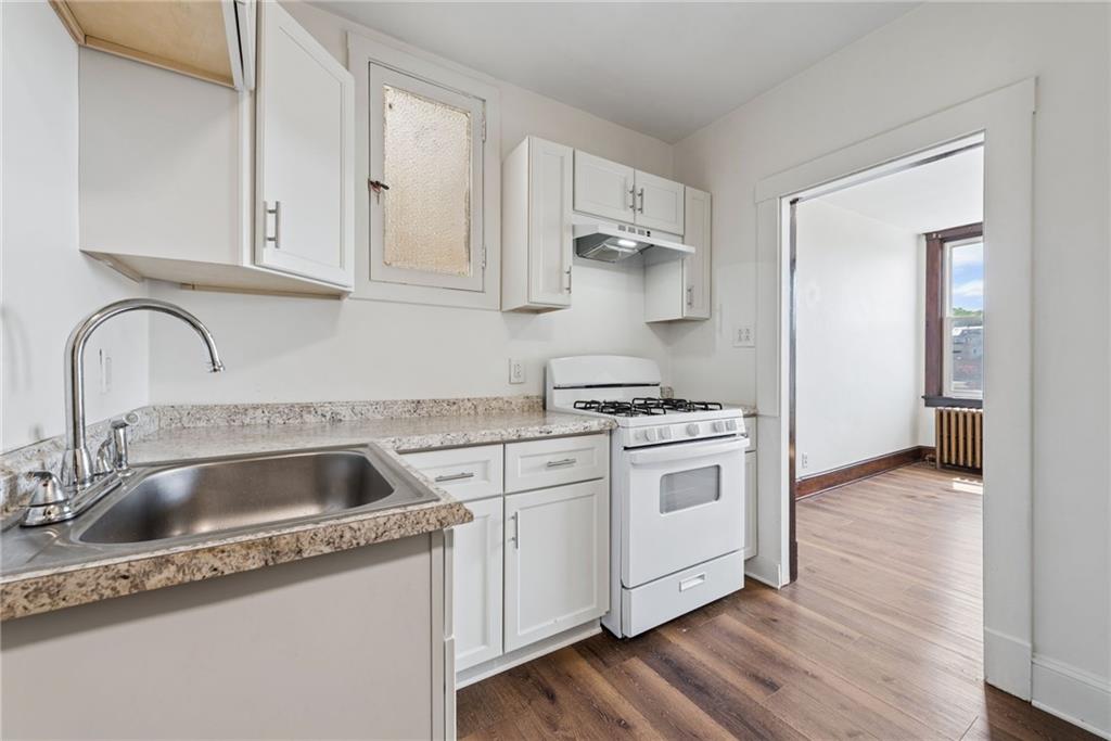 206 North Warren Avenue Apollo, PA 15613 - Photo 6 of 23 a kitchen with white cabinets and a sink