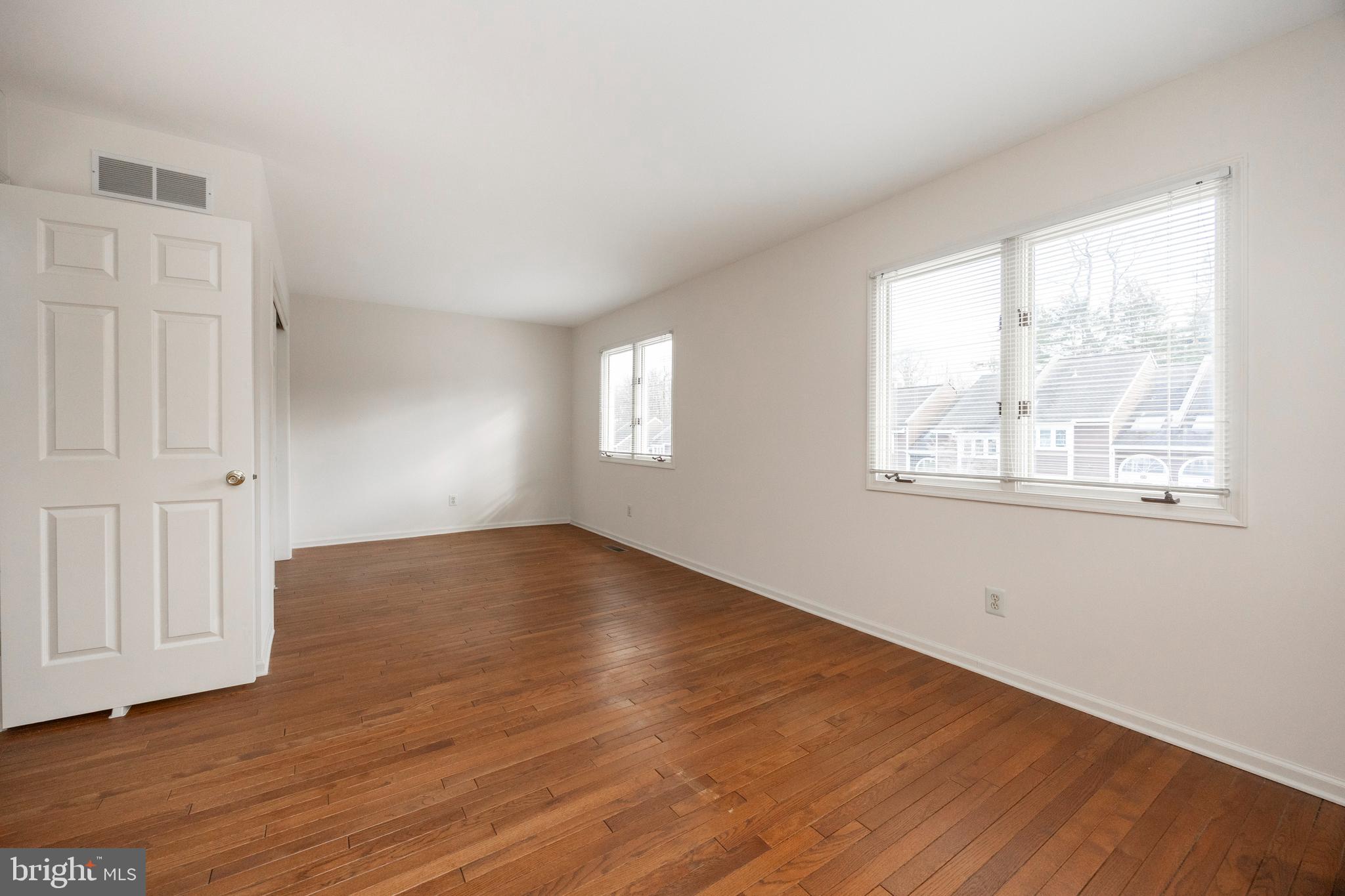 281 Fox Run Exton, PA 19341 - Photo 26 of 42 an empty room with wooden floor and windows