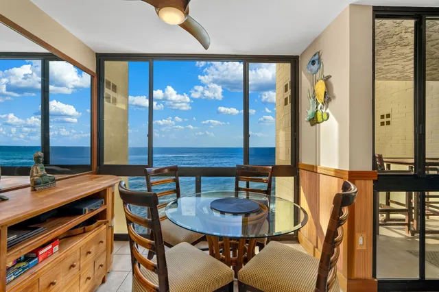 a view of a dining room with furniture and window