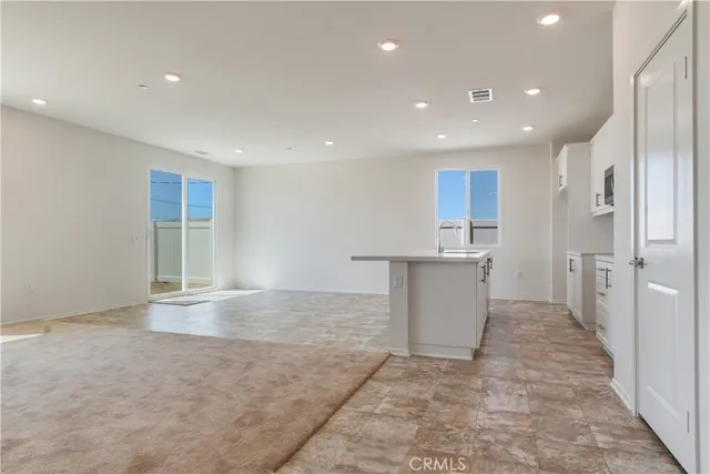 a view of a kitchen with a sink and cabinets
