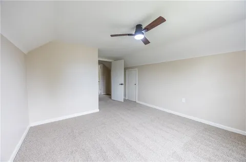 a view of an empty room with a ceiling fan
