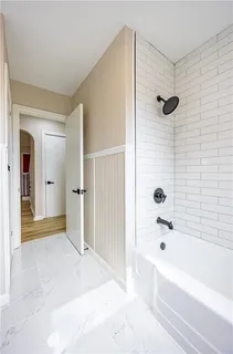 a bathroom with a bathtub and a shower