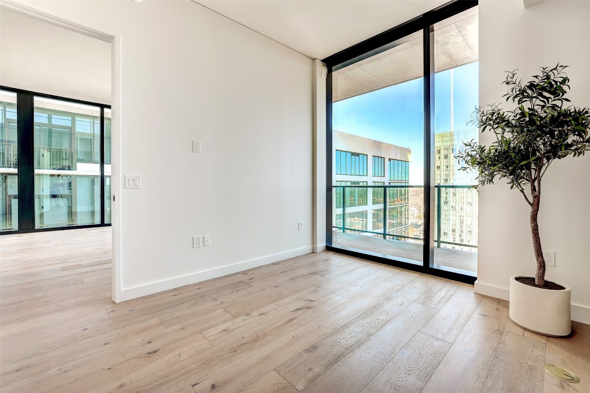 610 Davis Street, Unit 3008 Austin, TX 78701 - Photo 12 of 39 a view of a room with wooden floor and a potted plant