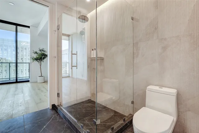 a bathroom with a toilet and a shower