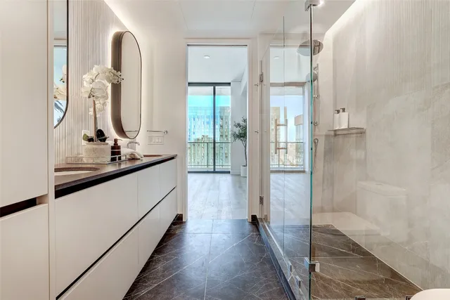 a en suite bathroom with a double vanity sink and a mirror