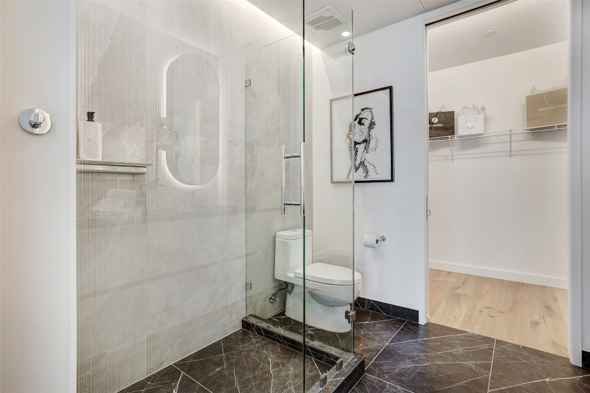 610 Davis Street, Unit 3008 Austin, TX 78701 - Photo 19 of 39 a white toilet sitting next to a bathroom sink