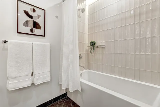 a bathroom with a bathtub and a shower