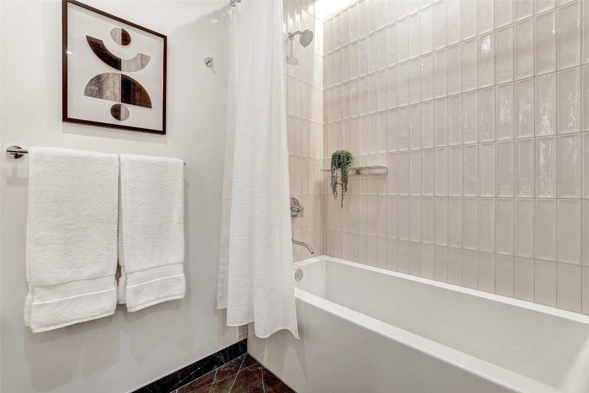 610 Davis Street, Unit 3008 Austin, TX 78701 - Photo 24 of 39 a bathroom with a bathtub and a shower