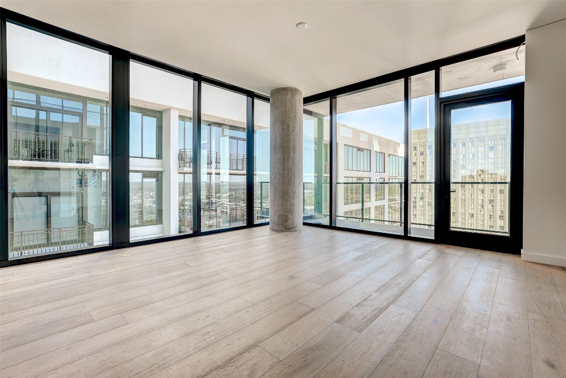610 Davis Street, Unit 3008 Austin, TX 78701 - Photo 2 of 39 a view of an empty room with wooden floor and a window