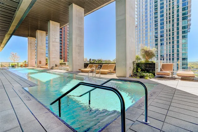 a swimming pool with outdoor seating and yard