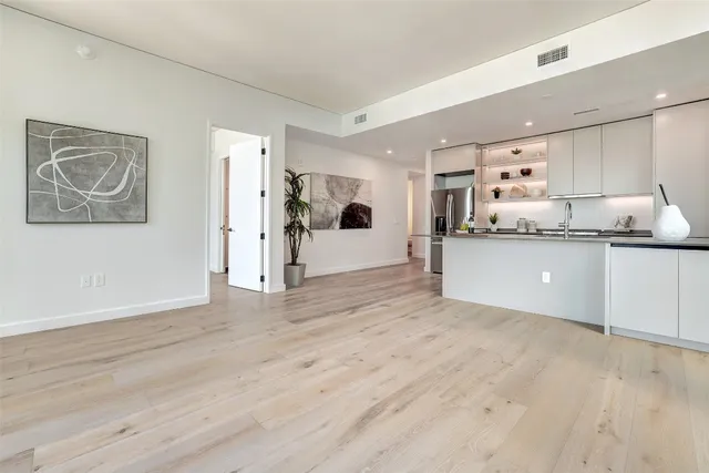 a view of a kitchen with a sink and a refrigerator