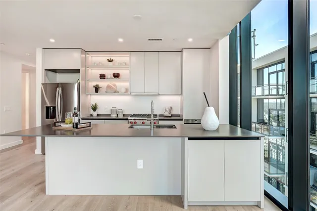 a kitchen with stainless steel appliances granite countertop a refrigerator and a sink